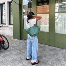 Woman standing in the street with a Dragon Diffusion bag