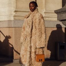 a photo of a woman wearing fur coat